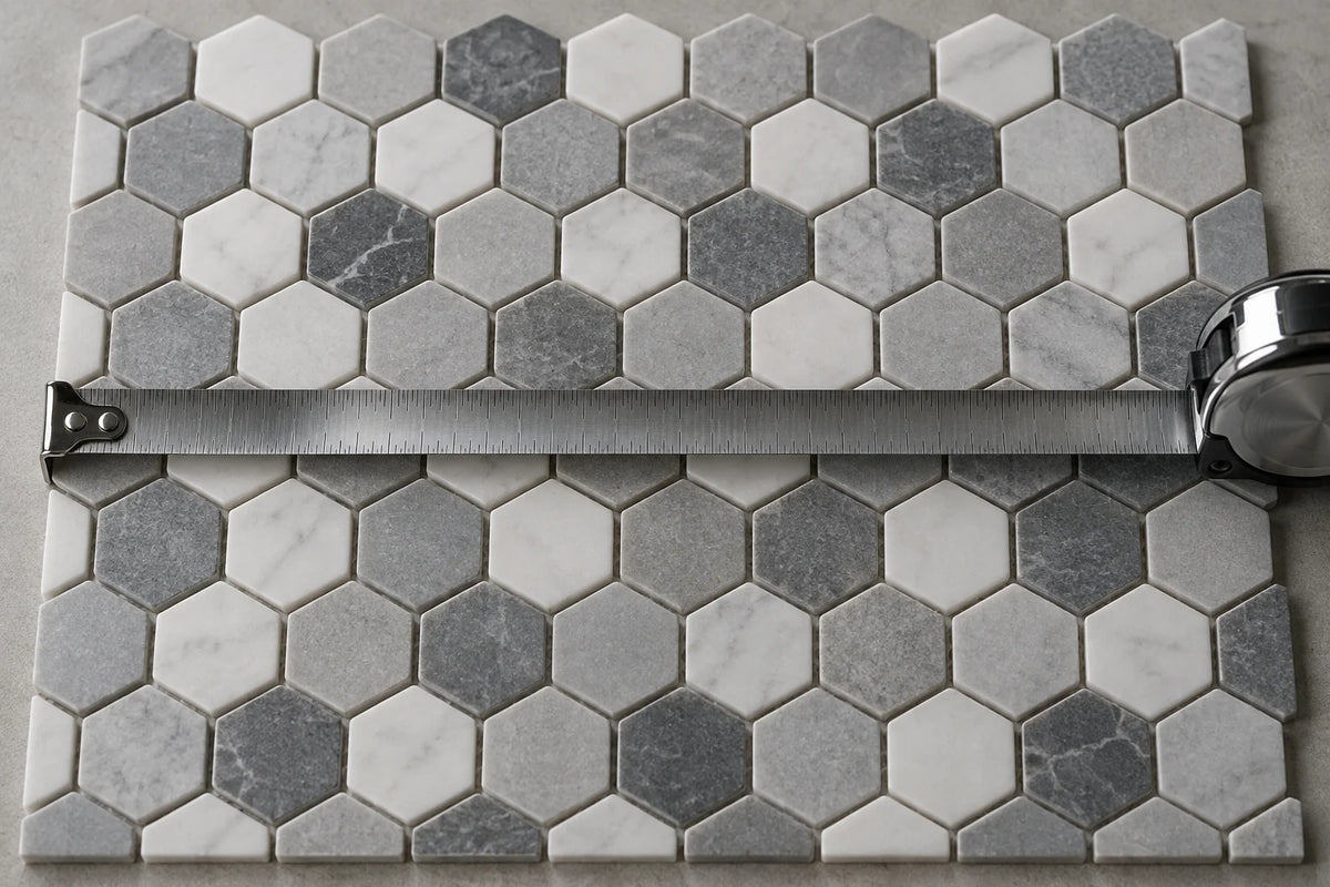 A flat sheet of hexagon mosaic with a steel tape measure drawn across it.