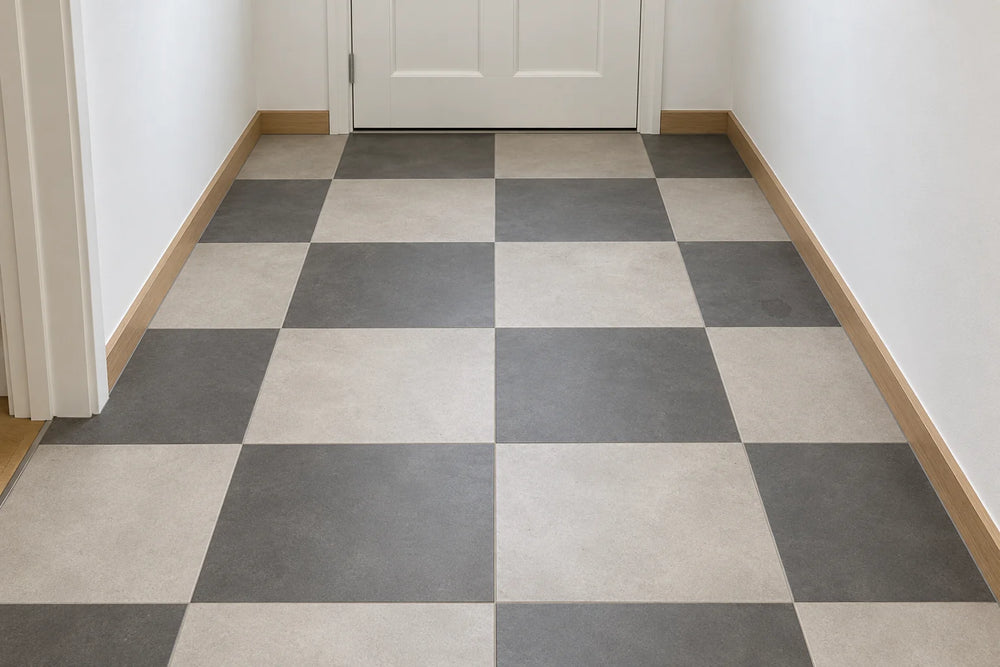 A hallway floor in a checkerboard of light grey and charcoal 600 × 600 mm tiles