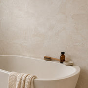 Atlas Ivory Stone-Look Tile beside a freestanding bath. Reference installation photographed by our supplier.