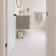 Carrara Petite Herringbone Mosaic Tile as a bathroom floor seen from the doorway. Reference installation photographed by our supplier.