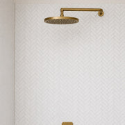 Carrara Petite Herringbone Mosaic Tile across two shower walls. Reference installation photographed by our supplier.