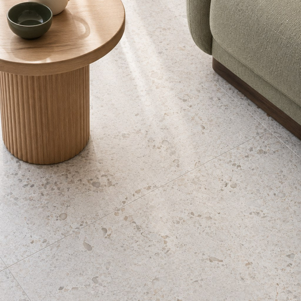 Haven White Terrazzo-Look Tile as a living room floor, close view. Reference installation photographed by our supplier.