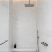 Pietra Luna Marble-Look Tile in a walk-in shower, walls and floor. Reference installation photographed by our supplier.