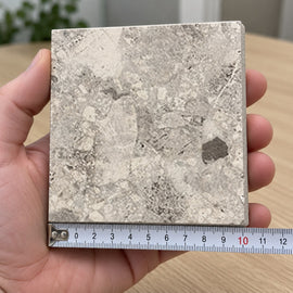 Haven In/Out Terrazzo-Look Tile sample held in a hand.