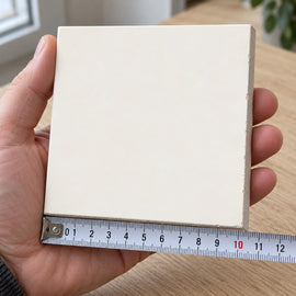 Pietra Bianco Marble-Look Tile sample held in a hand.