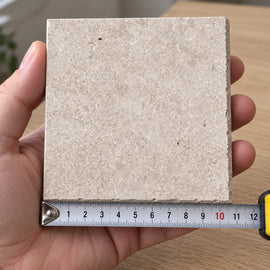 Quarry Sand Concrete-Look Tile sample held in a hand.