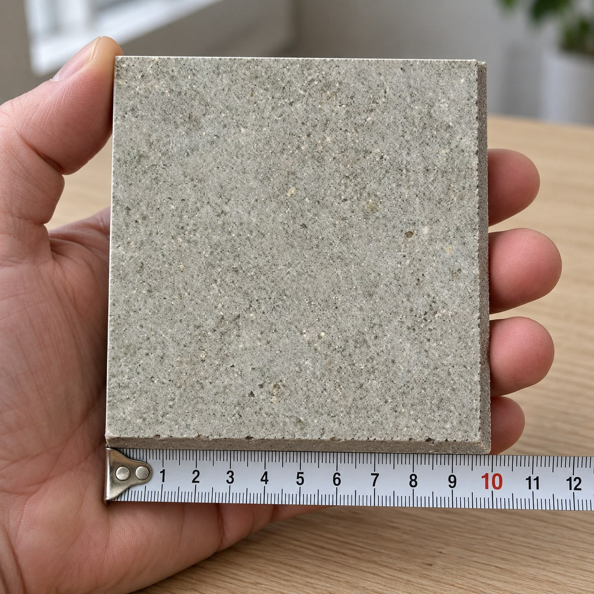 Quarry Stone Concrete-Look Tile sample held in a hand.
