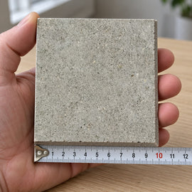 Quarry Stone Concrete-Look Tile sample held in a hand.