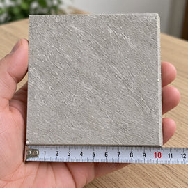 Ridge Grey Stone-Look Tile sample held in a hand.