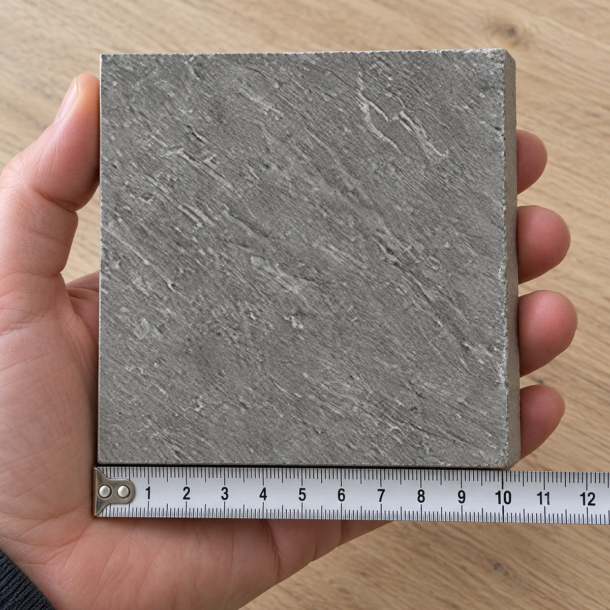 Ridge Slate Stone-Look Tile sample held in a hand.