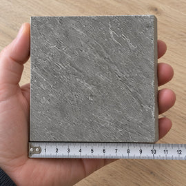 Ridge Slate Stone-Look Tile sample held in a hand.