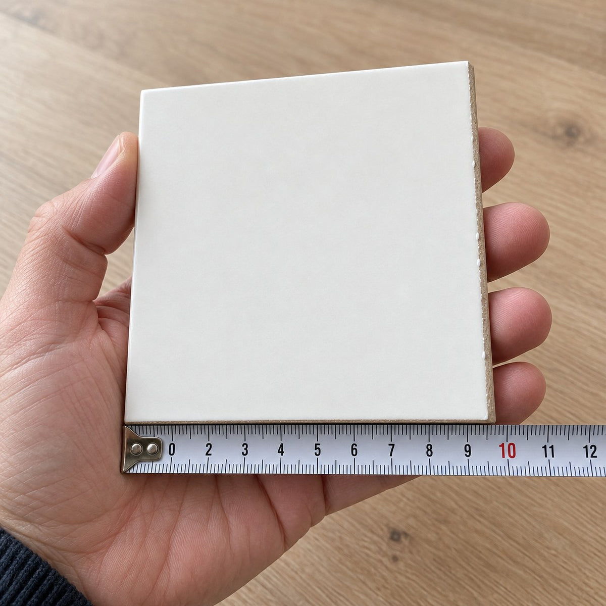 Studio Linen Subway Tile sample held in a hand.