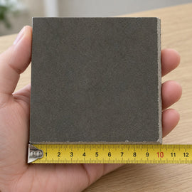 Urban Graphite Concrete-Look Tile sample held in a hand.